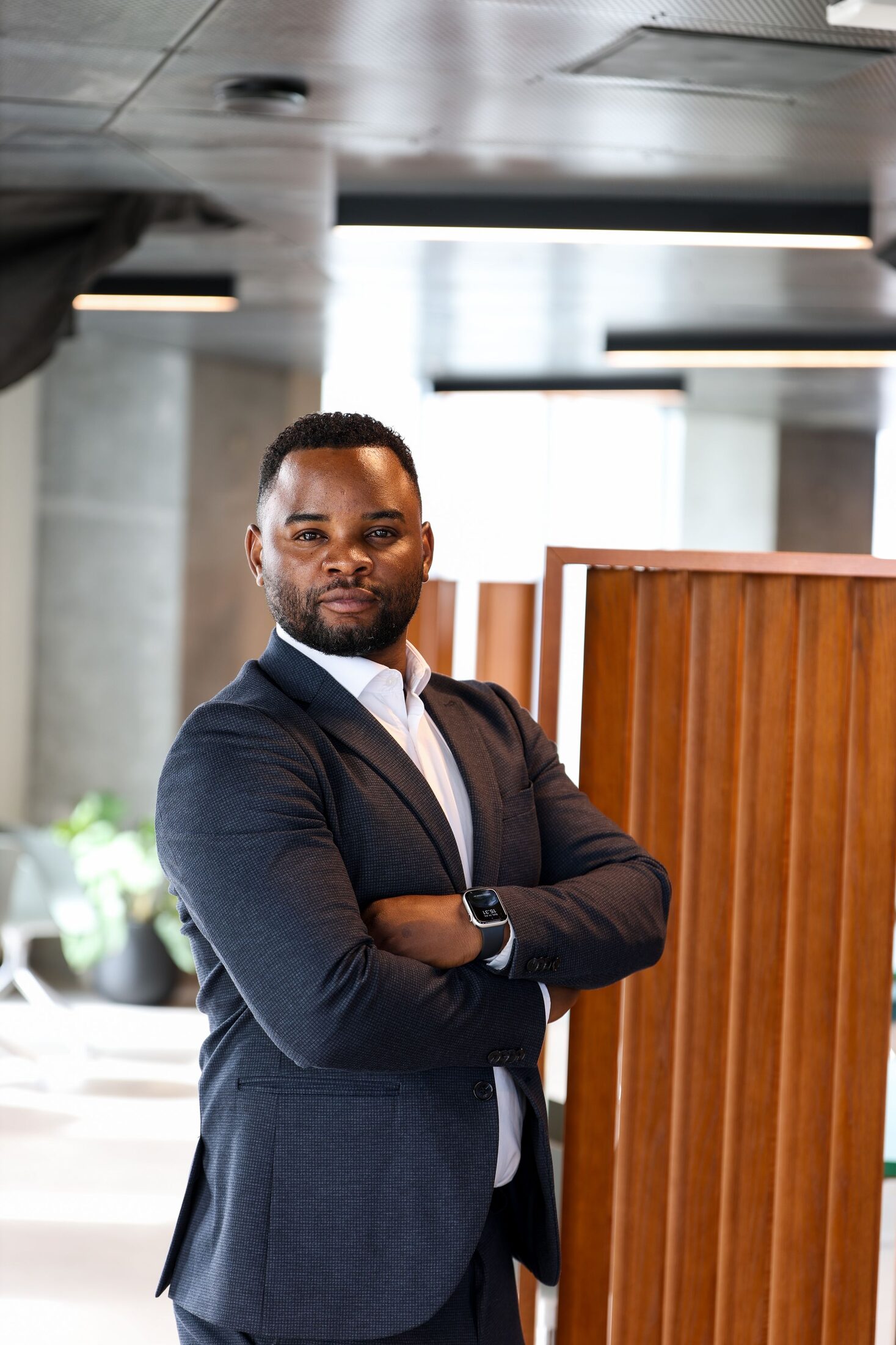 A commercial property professional standing in the foyer of a modern building